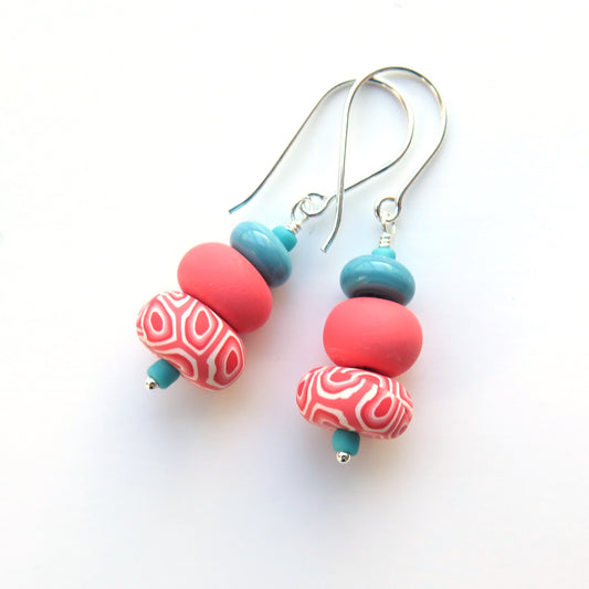 Colorful beaded earrings on a white background